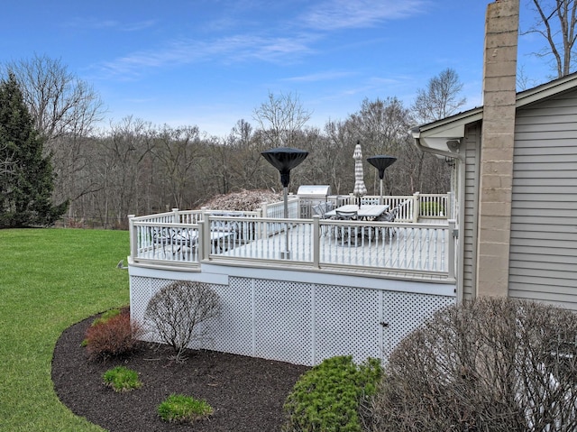 wooden terrace featuring a yard