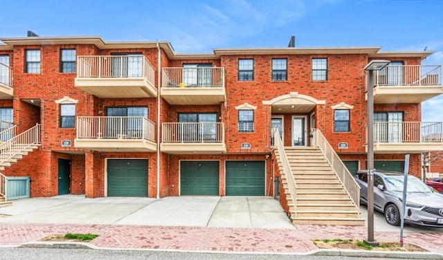 2-21 Constitution Pl Unit A, College Point, NY 11356 - view of front of property featuring stairs, brick siding, and a garage