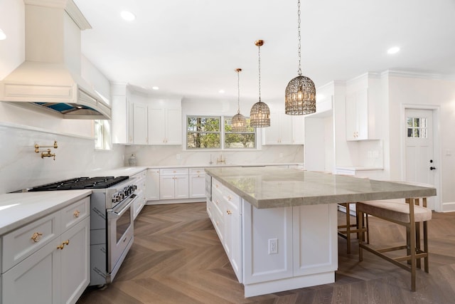 56 Drake Rd, Scarsdale, NY 10583 - kitchen featuring high end stainless steel range, custom exhaust hood, a center island, a breakfast bar area, and plenty of natural light