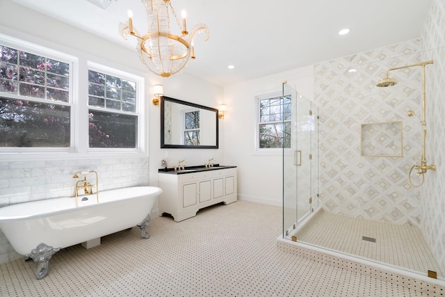 56 Drake Rd, Scarsdale, NY 10583 - bathroom with a chandelier, a shower stall, a freestanding bath, vanity, and recessed lighting