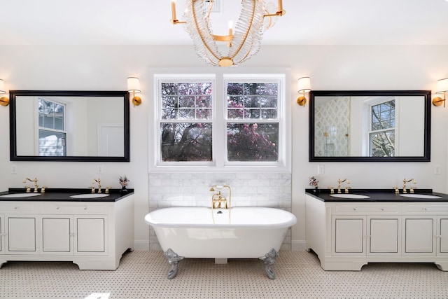 56 Drake Rd, Scarsdale, NY 10583 - full bath with a chandelier, a freestanding bath, two vanities, and tile patterned floors