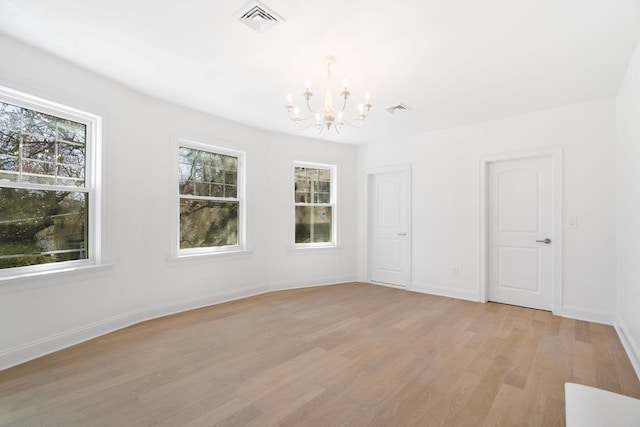 56 Drake Rd, Scarsdale, NY 10583 - spare room featuring a chandelier, light wood-style floors, and baseboards