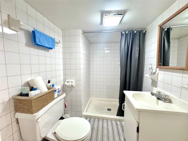 bathroom with toilet, tile walls, a shower stall, tasteful backsplash, and vanity