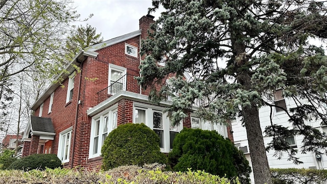 view of home's exterior featuring a chimney and brick siding