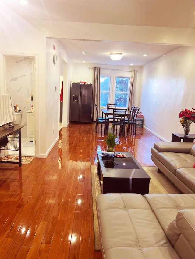 living room featuring recessed lighting, wood finished floors, and baseboards