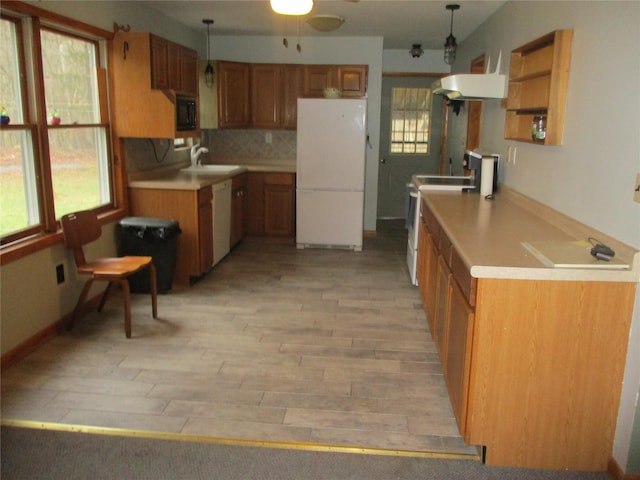 579 State Route 55, Napanoch, NY 12458 - kitchen featuring white appliances, light wood-style flooring, a wealth of natural light, brown cabinets, and a sink