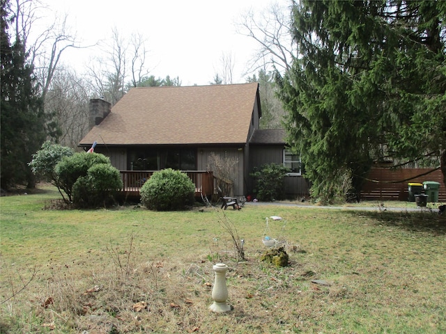 579 State Route 55, Napanoch, NY 12458 - exterior space featuring a shingled roof, a wooden deck, a chimney, and a lawn