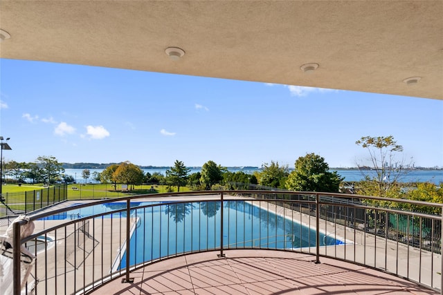 view of swimming pool featuring a fenced in pool, a patio, and a water view