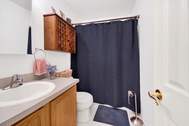 bathroom with a shower with curtain, toilet, vanity, and tile patterned floors