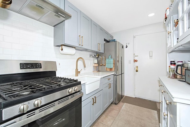kitchen with a sink, stainless steel appliances, light countertops, and custom range hood