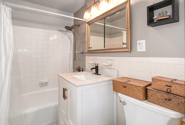 full bathroom with tile walls, shower / bath combo, vanity, and toilet