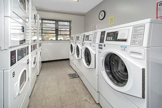 common laundry area featuring stacked washer / drying machine and washer and clothes dryer