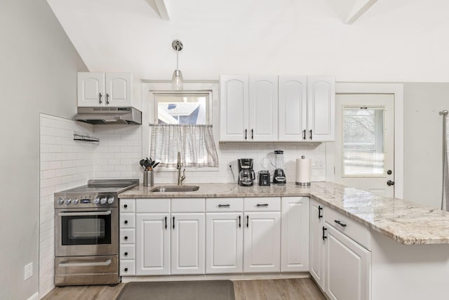 572A Montauk Hwy, Westhampton Beach, NY 11978 - kitchen featuring light wood finished floors, stainless steel electric range oven, under cabinet range hood, and a sink