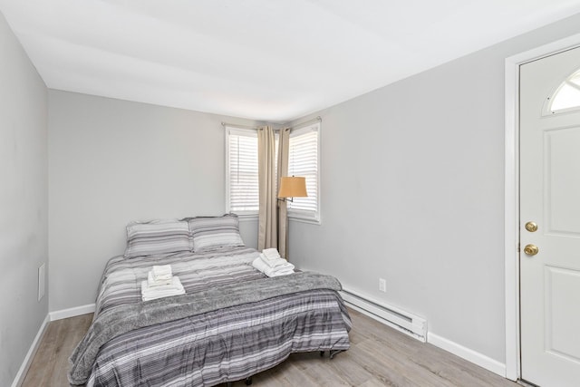 572A Montauk Hwy, Westhampton Beach, NY 11978 - bedroom with baseboards, baseboard heating, and wood finished floors