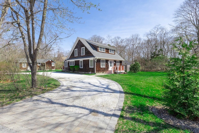 572A Montauk Hwy, Westhampton Beach, NY 11978 - view of front of house with roof with shingles, a front yard, and curved driveway