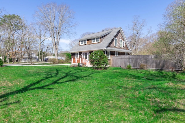 572A Montauk Hwy, Westhampton Beach, NY 11978 - exterior space with a porch, a front yard, and a shingled roof