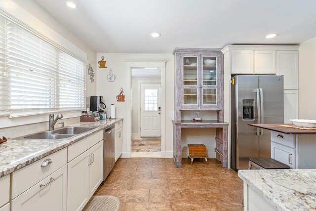 572A Montauk Hwy, Westhampton Beach, NY 11978 - kitchen featuring white cabinets, a sink, recessed lighting, glass insert cabinets, and appliances with stainless steel finishes