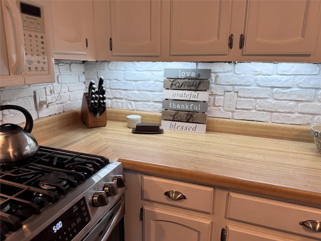 190 Union St, Montgomery, NY 12549 - kitchen with white microwave, decorative backsplash, stainless steel gas range oven, and light countertops