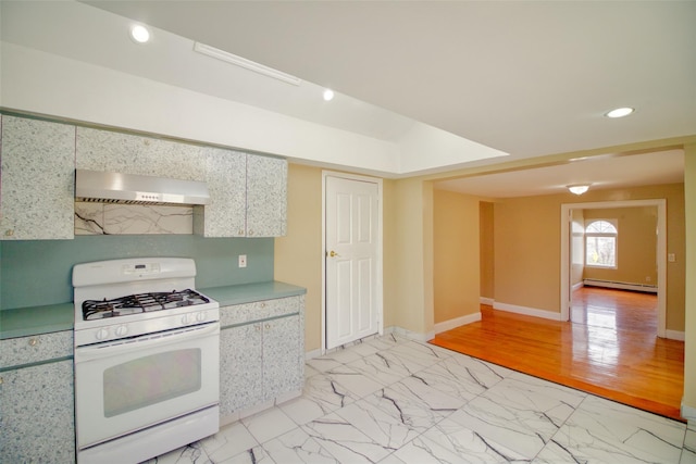 kitchen featuring a baseboard radiator, wall chimney range hood, white gas range, and recessed lighting