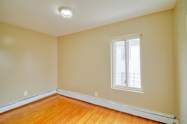 unfurnished room with light wood-style flooring, a baseboard radiator, and baseboards