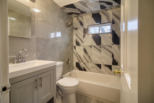 full bathroom with tasteful backsplash, toilet, tile walls,  shower combination, and vanity