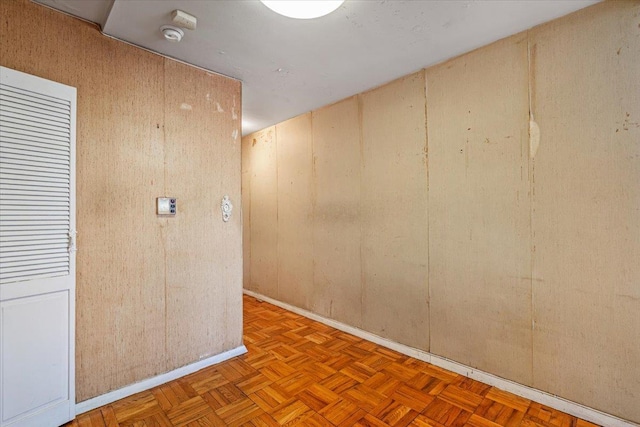 90-59 56th Ave Unit 2J, Elmhurst, NY 11373 - spare room featuring baseboards and wooden walls