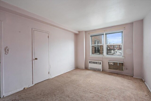 90-59 56th Ave Unit 2J, Elmhurst, NY 11373 - carpeted spare room featuring baseboards and radiator