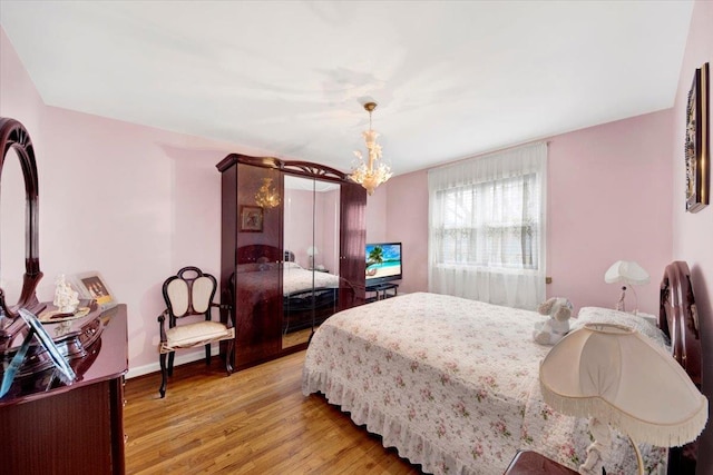 2559 Seymour Ave, Bronx, NY 10469 - bedroom featuring light wood-style flooring and a notable chandelier