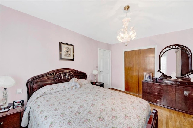 2559 Seymour Ave, Bronx, NY 10469 - bedroom featuring a closet, a chandelier, and light wood-type flooring