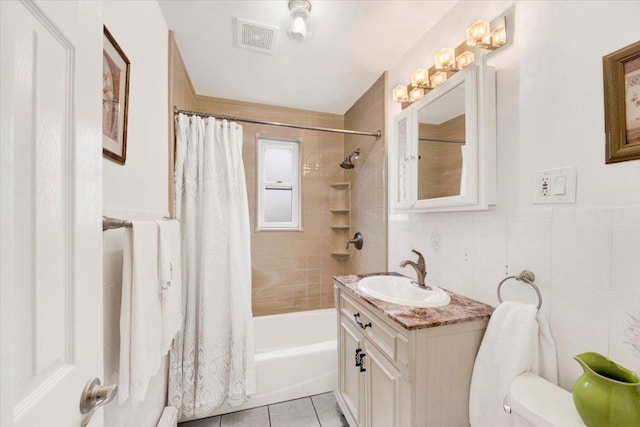 2559 Seymour Ave, Bronx, NY 10469 - full bath with tile patterned floors, visible vents, toilet, tile walls, and shower / tub combo with curtain