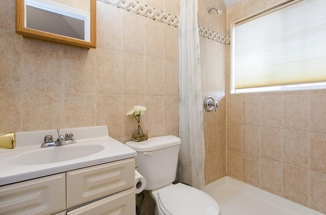 1933 Colden Ave, Bronx, NY 10462 - bathroom featuring toilet, tiled shower, vanity, and tile walls