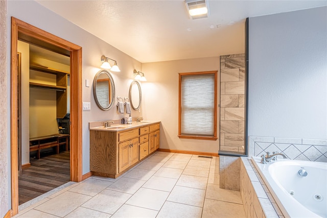 26 Cowboy Trl, Saugerties, NY 12477 - full bath featuring a whirlpool tub, baseboards, double vanity, tile patterned flooring, and a sink
