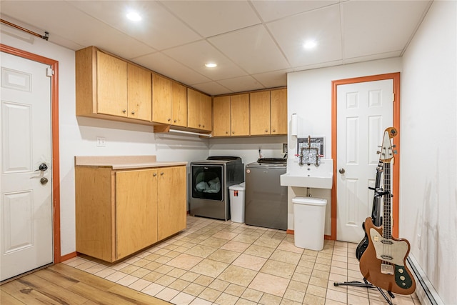 26 Cowboy Trl, Saugerties, NY 12477 - laundry area with baseboards, washer and clothes dryer, cabinet space, a baseboard radiator, and a sink