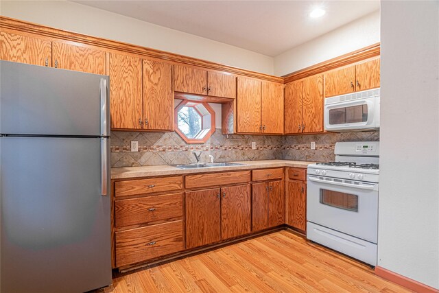 26 Cowboy Trl, Saugerties, NY 12477 - kitchen with white appliances, tasteful backsplash, light countertops, a sink, and brown cabinets