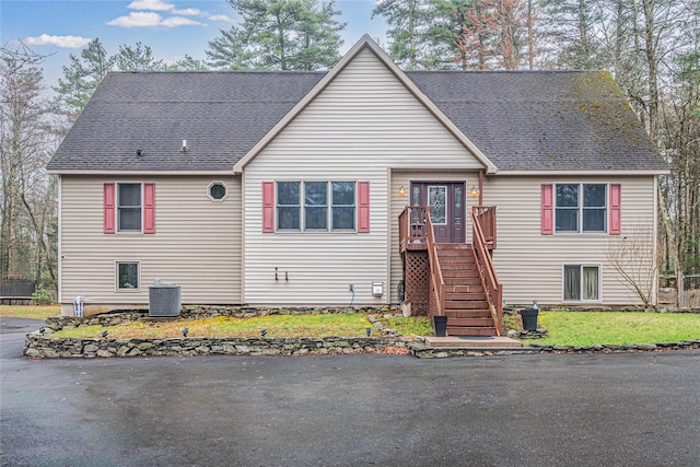 26 Cowboy Trl, Saugerties, NY 12477 - view of front of home with central AC, a front yard, stairway, and roof with shingles