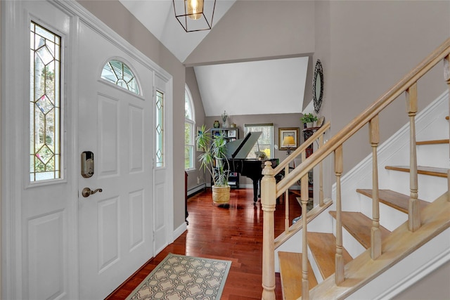 entrance foyer with stairway, high vaulted ceiling, and wood finished floors