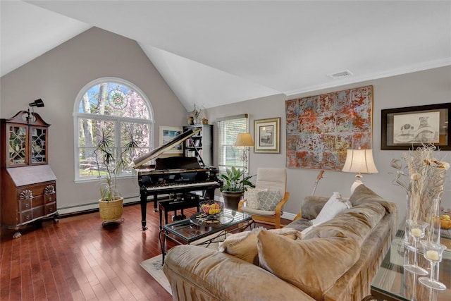 living area with a baseboard heating unit, lofted ceiling, visible vents, and a healthy amount of sunlight