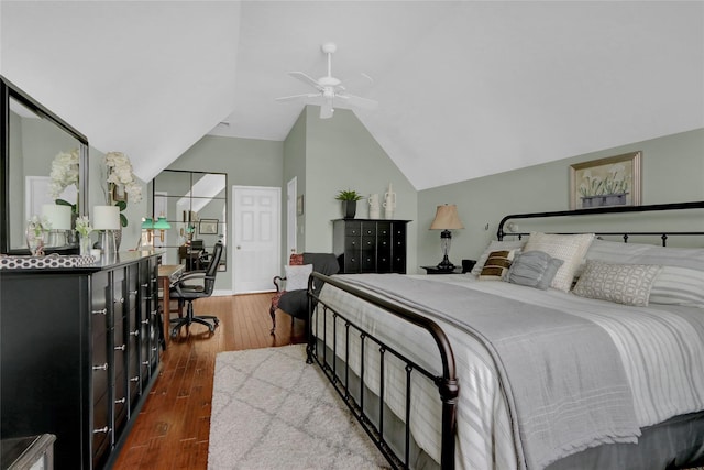 bedroom featuring a ceiling fan, lofted ceiling, and dark wood-style flooring