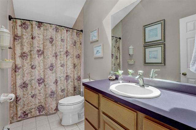 bathroom featuring toilet, vanity, tile patterned floors, and curtained shower