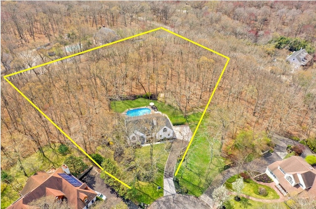 birds eye view of property with a view of trees