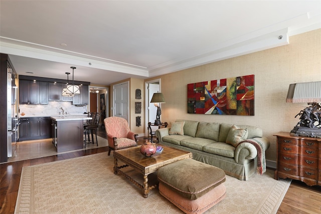 living area with a raised ceiling and wood finished floors