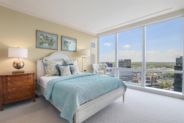 bedroom with visible vents, floor to ceiling windows, and carpet floors
