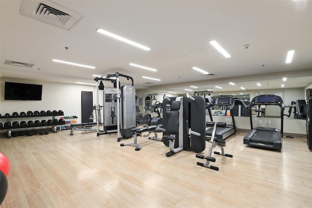workout area featuring visible vents and wood finished floors