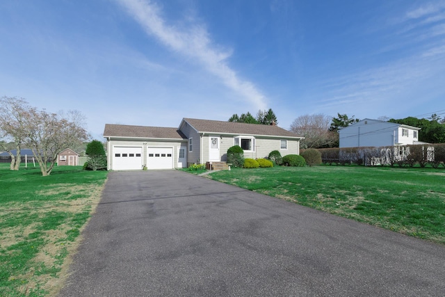 ranch-style home featuring a garage, driveway, and a front yard