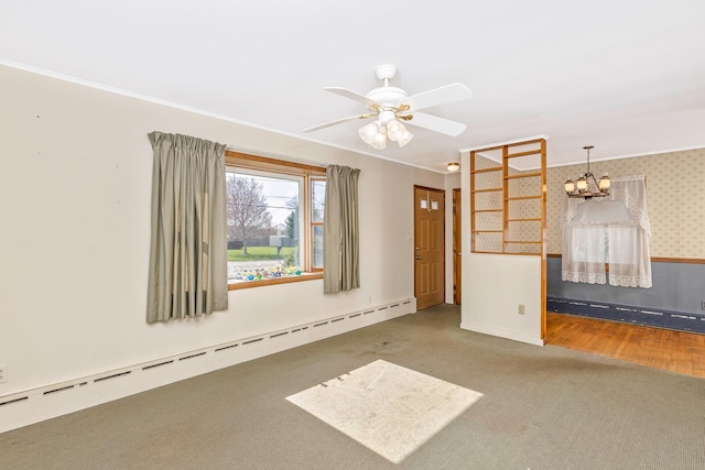 empty room with baseboard heating, ceiling fan with notable chandelier, a baseboard heating unit, carpet floors, and ornamental molding
