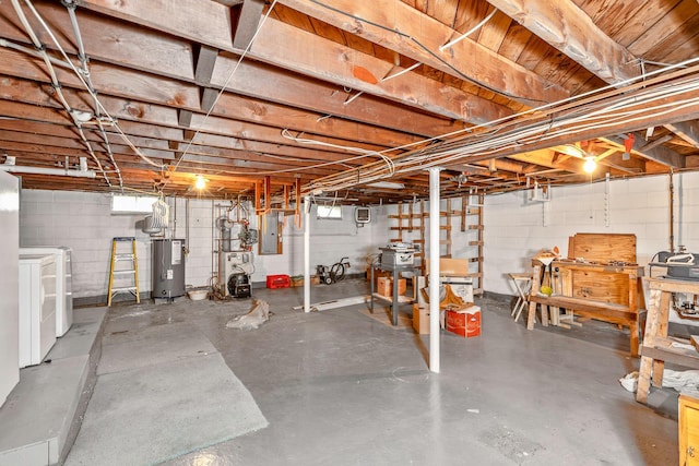 below grade area featuring water heater, a heating unit, and washer and clothes dryer