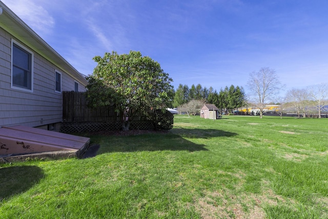 view of yard featuring an outbuilding and a storage shed