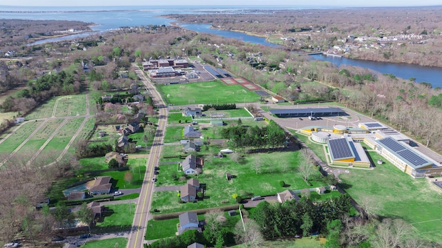drone / aerial view featuring a forest view and a water view