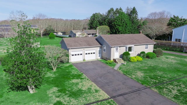single story home with driveway and a front yard