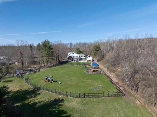 aerial view featuring a forest view and a rural view